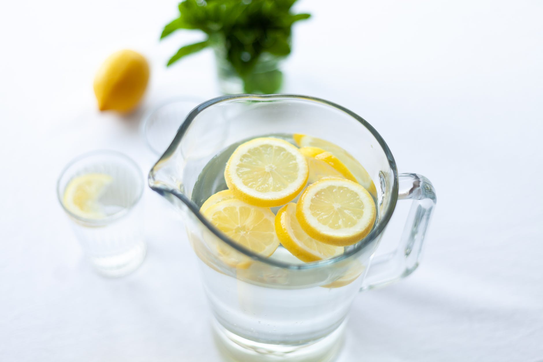 sliced lemon fruit in glass picher